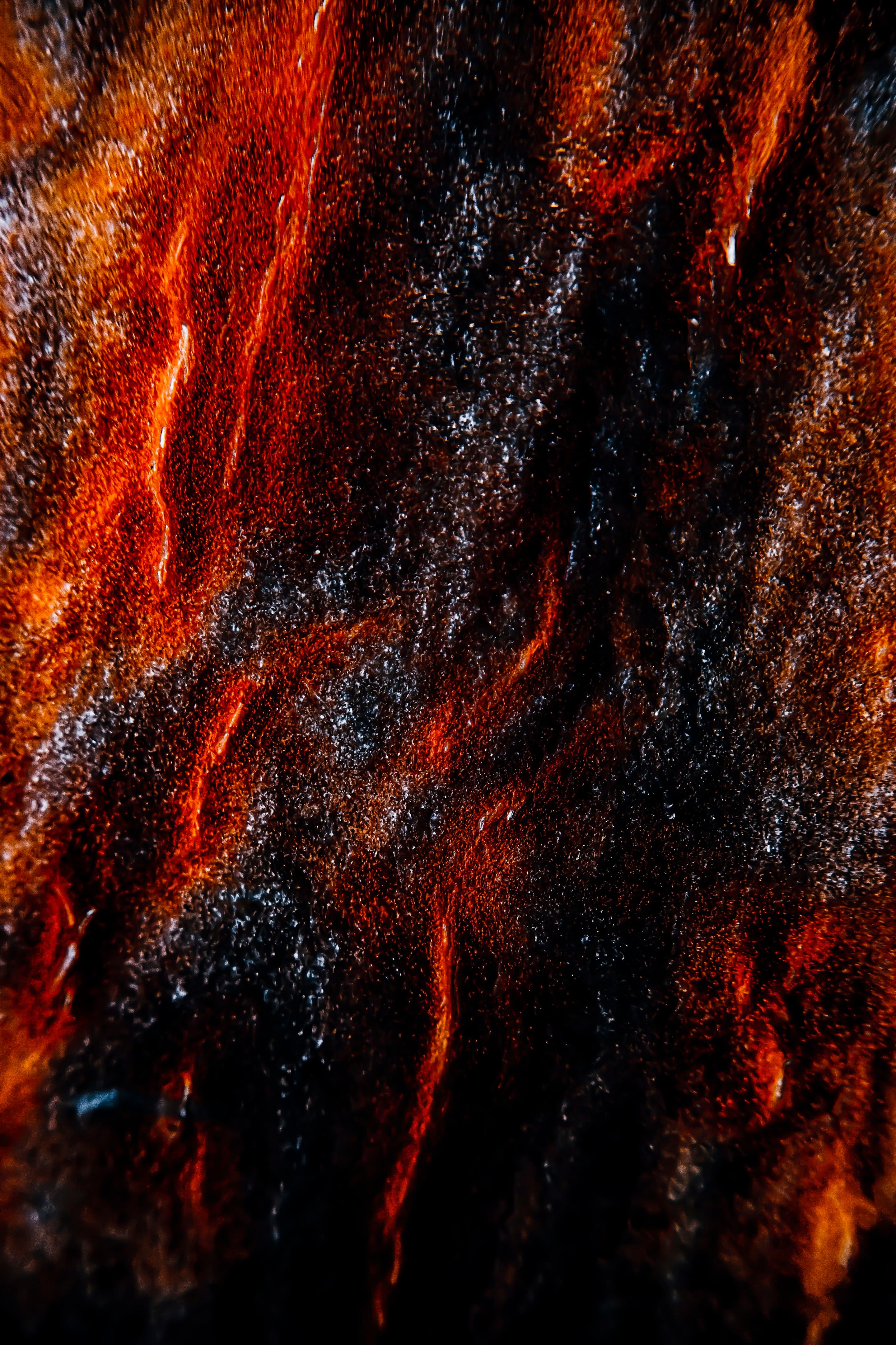 Molten rock glowing orange from within the dark earth